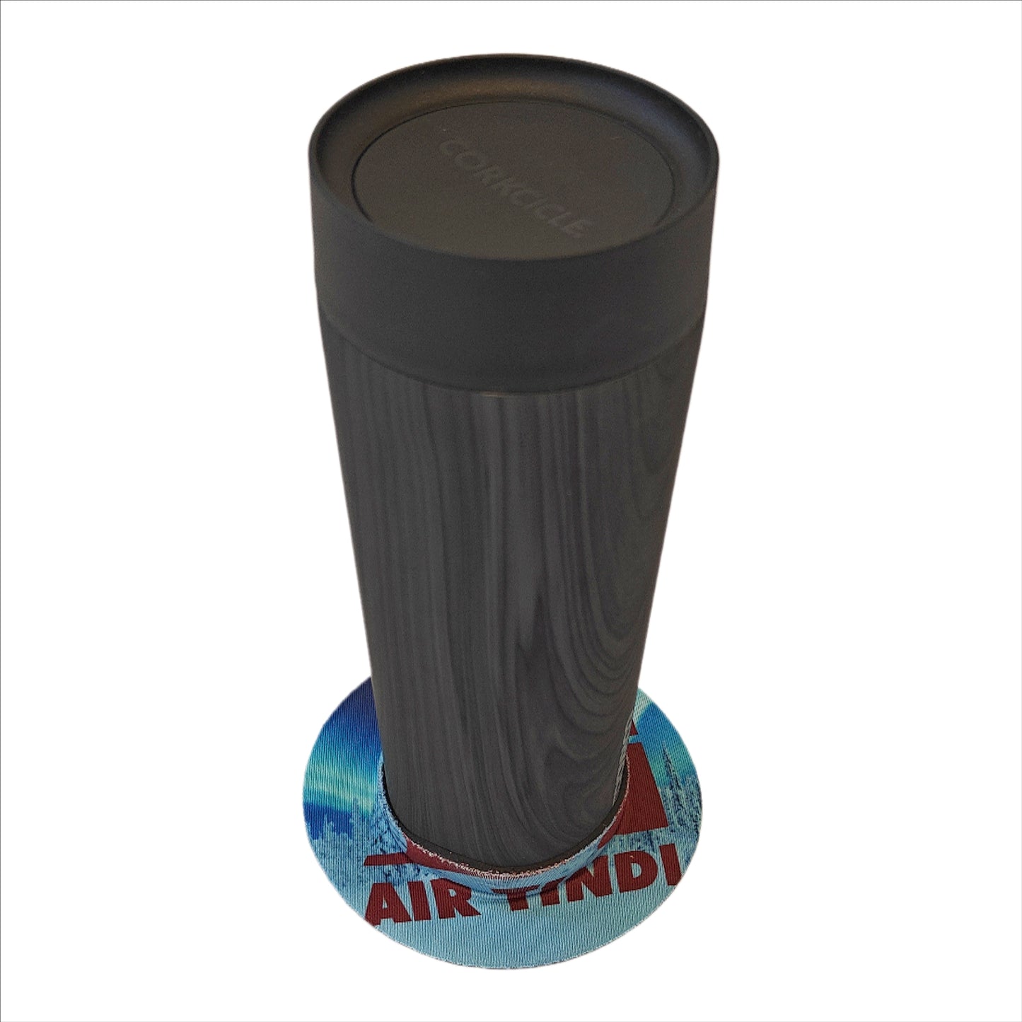 Air Tindi Lil’ Sucker cup holder featuring the Air Tindi Logo securing a travel mug on a countertop