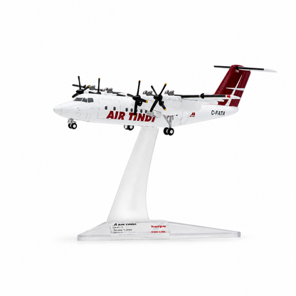 A scale model of an Air Tindi Dash 7 aircraft on a clear plastic display stand, photographed against a seamless white background.