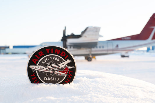 Air Tindi Classic Dash 7 Sew-On Patch in the snow with a Dash 7 in the background