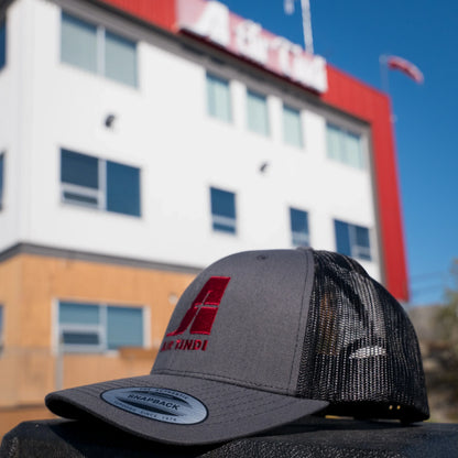 Air Tindi Essential Trucker Cap in Charcoal in front of the Air Tindi Float Base