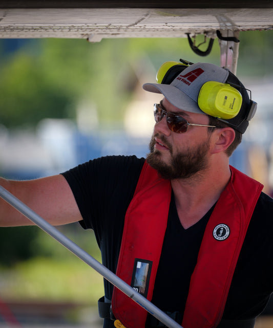 Model wearing an Air Tindi Essential Trucker Cap in gray heather
