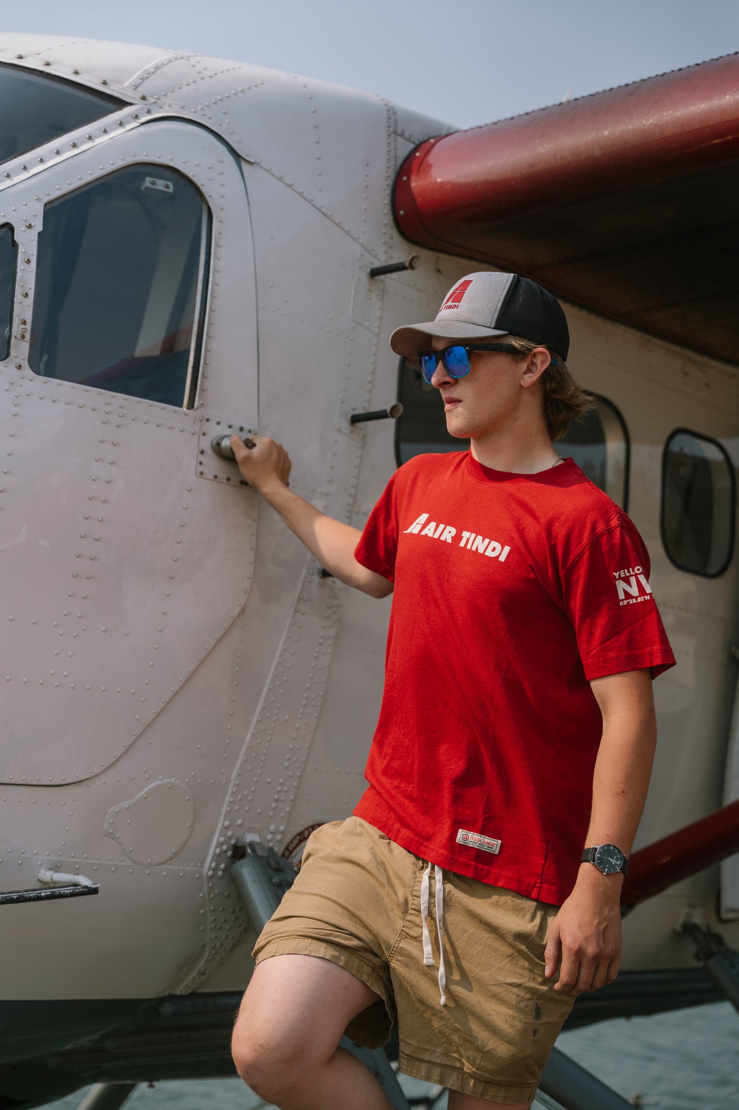 Model wearing an Air Tindi Legacy T-Shirt in mens, while wearing an Essential Trucker Cap