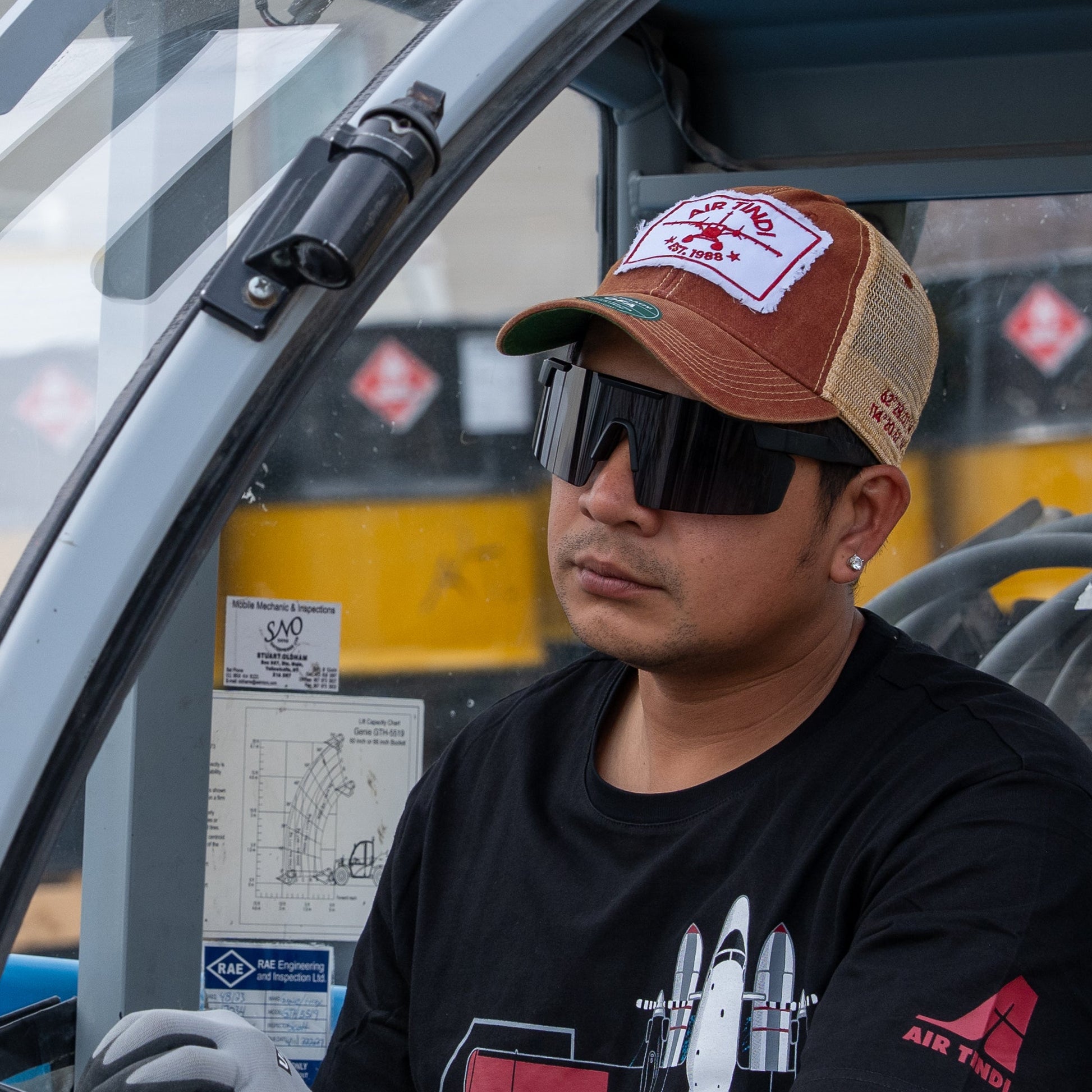 Model wearing Air Tindi Legacy Trucker Hat in red and gold