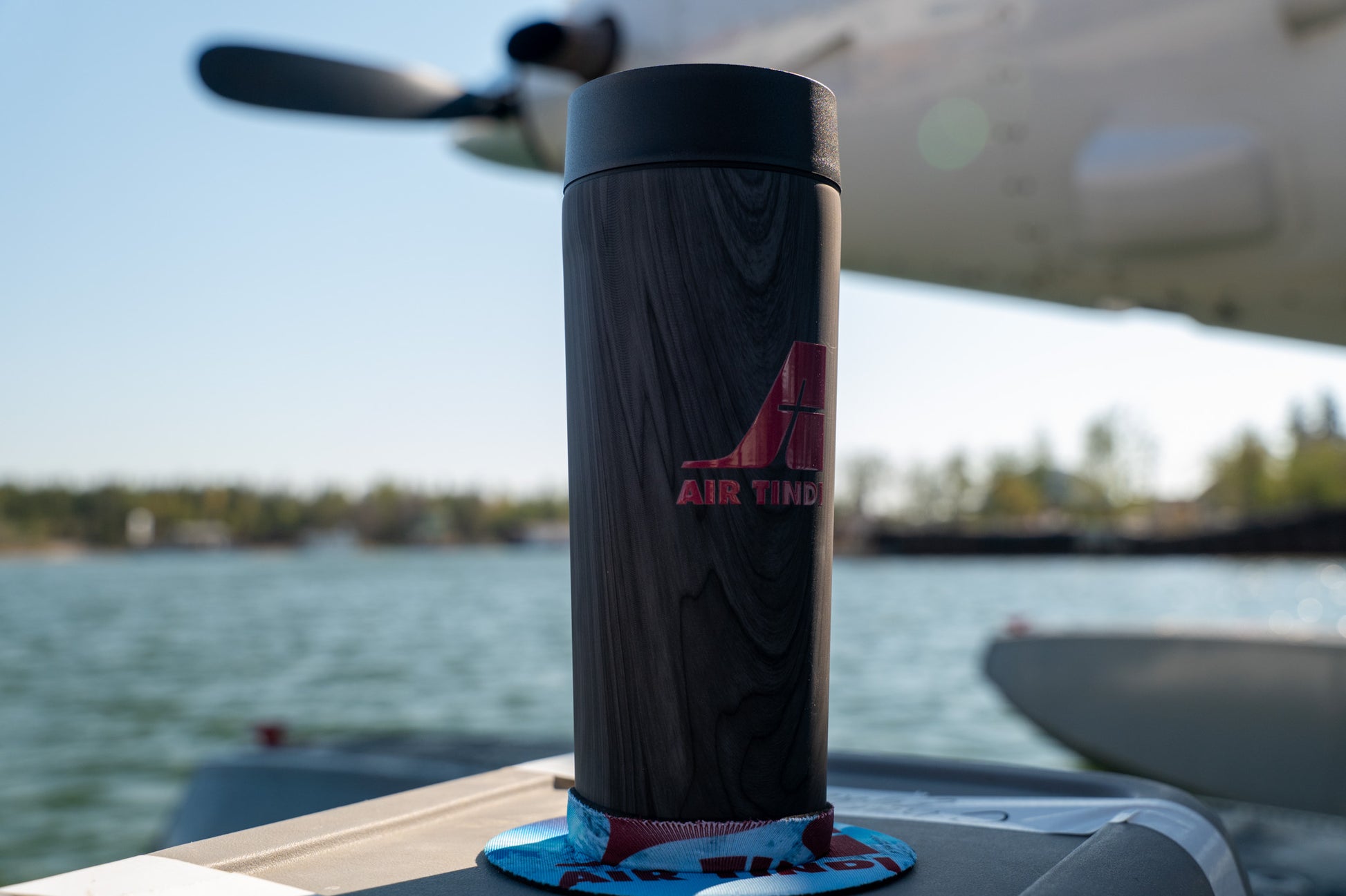 Air Tindi Lil’ Sucker cup holder featuring an Air Tindi Logo securing an Air Tindi Signature Corkcicle Commuter Cup