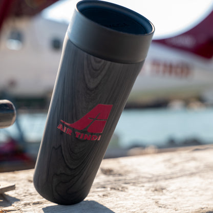 Air Tindi Signature Corkcicle Commuter Cup in Burnt Wood in front of a floatplane