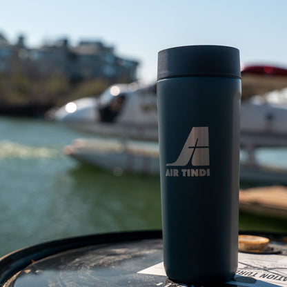 Air Tindi Signature Corkcicle Commuter Cup in Rucksack in front of a floatplane