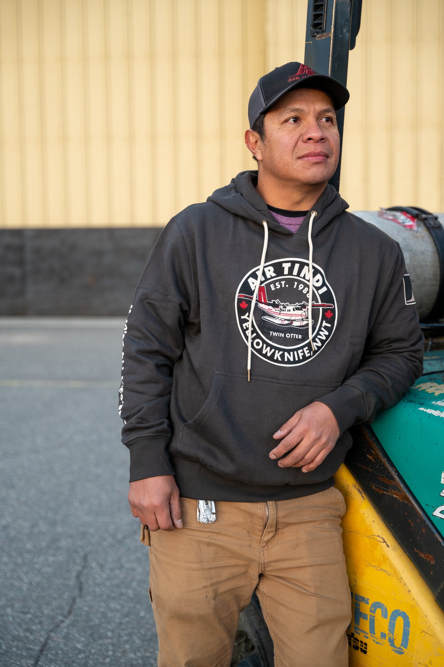 Model wearing an Air Tindi Twin Otter Unisex Hoodie outdoors