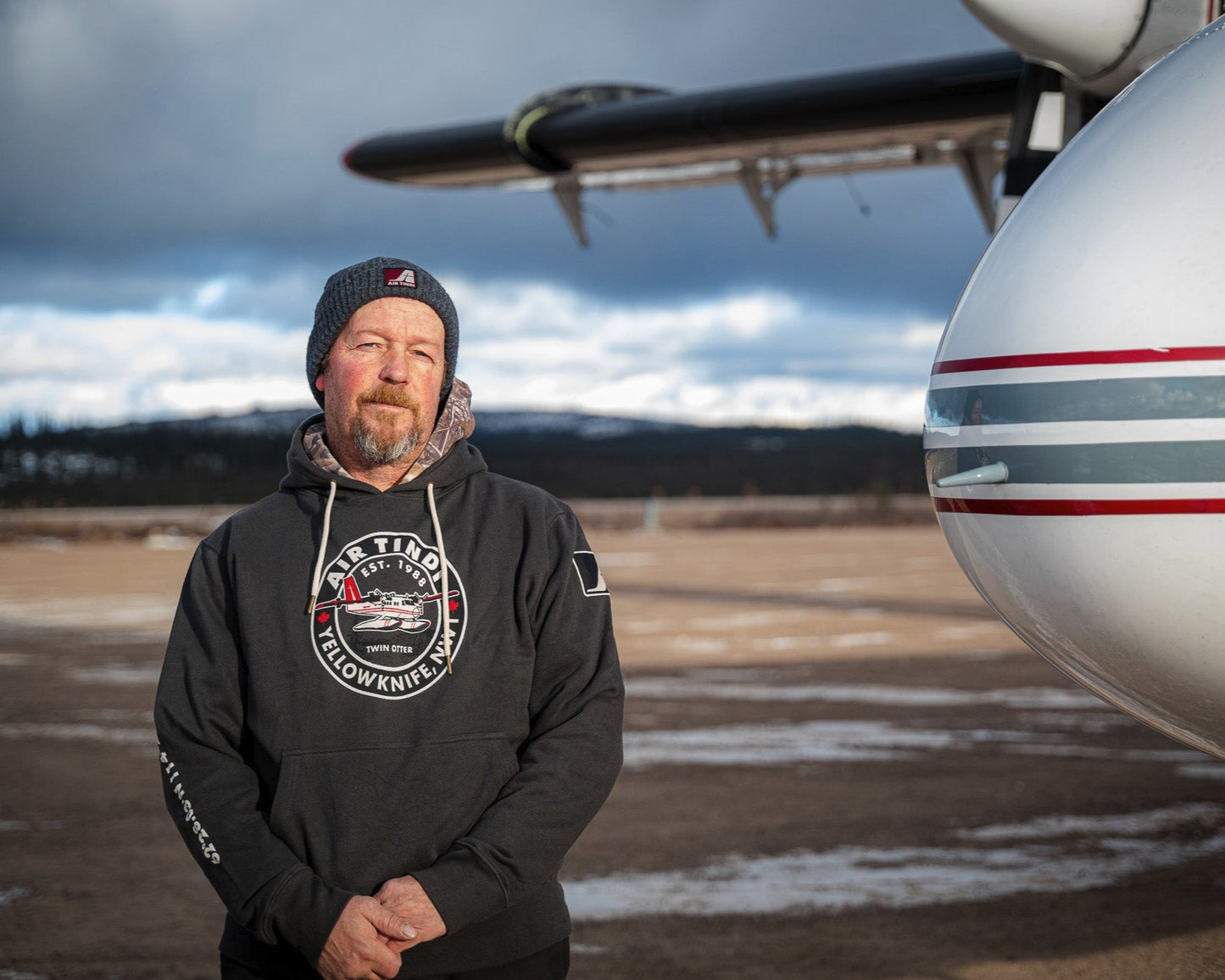 Model wearing an Air Tindi Twin Otter Hoodie outdoors