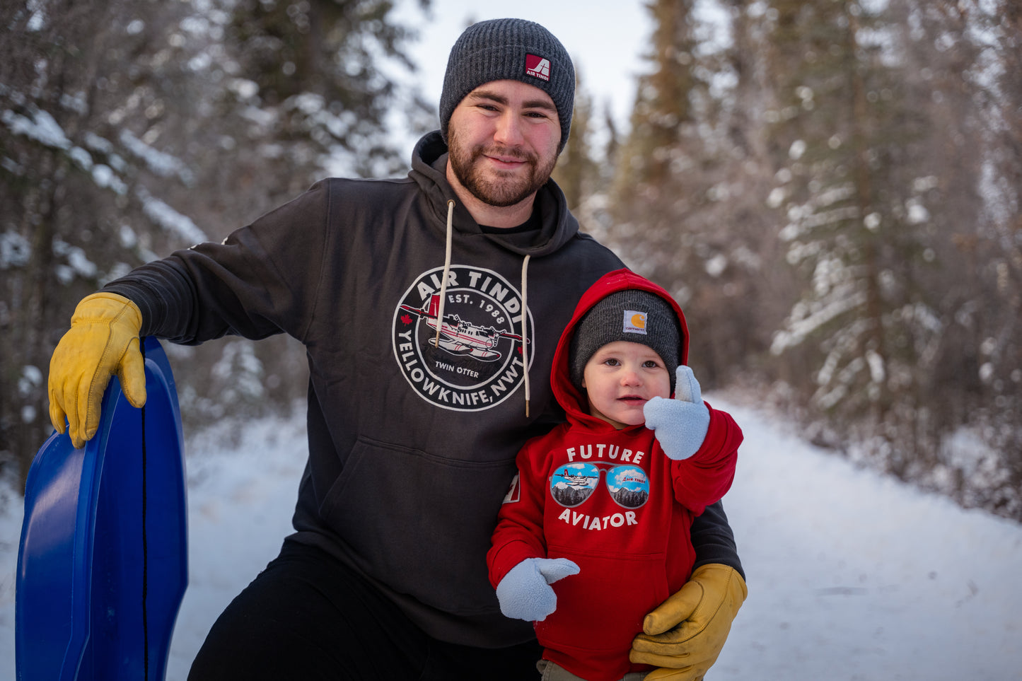 Model wearing an Air Tindi Twin Otter Hoodie, alongside a Future Aviator Youth Hoodie